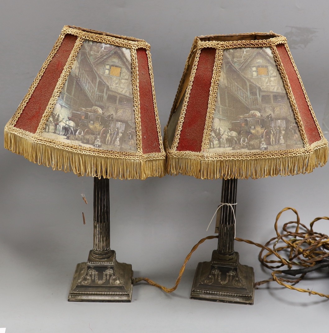 A pair of late Victorian silver Corinthian column candlesticks, now drilled and converted to table lamps, James Dixon & Sons, Sheffield, 1890, weighted, with decorative shades, overall 45cms high.